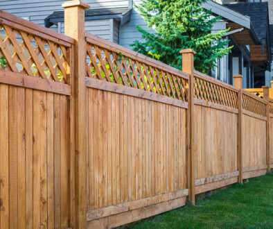 A Wooden Privacy Fence With a Lattice Top in Front of a House How to Build a Privacy Fence